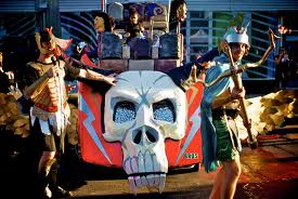 The BROS Members of BROS performing with an art car covered with skulls and lightning bolts