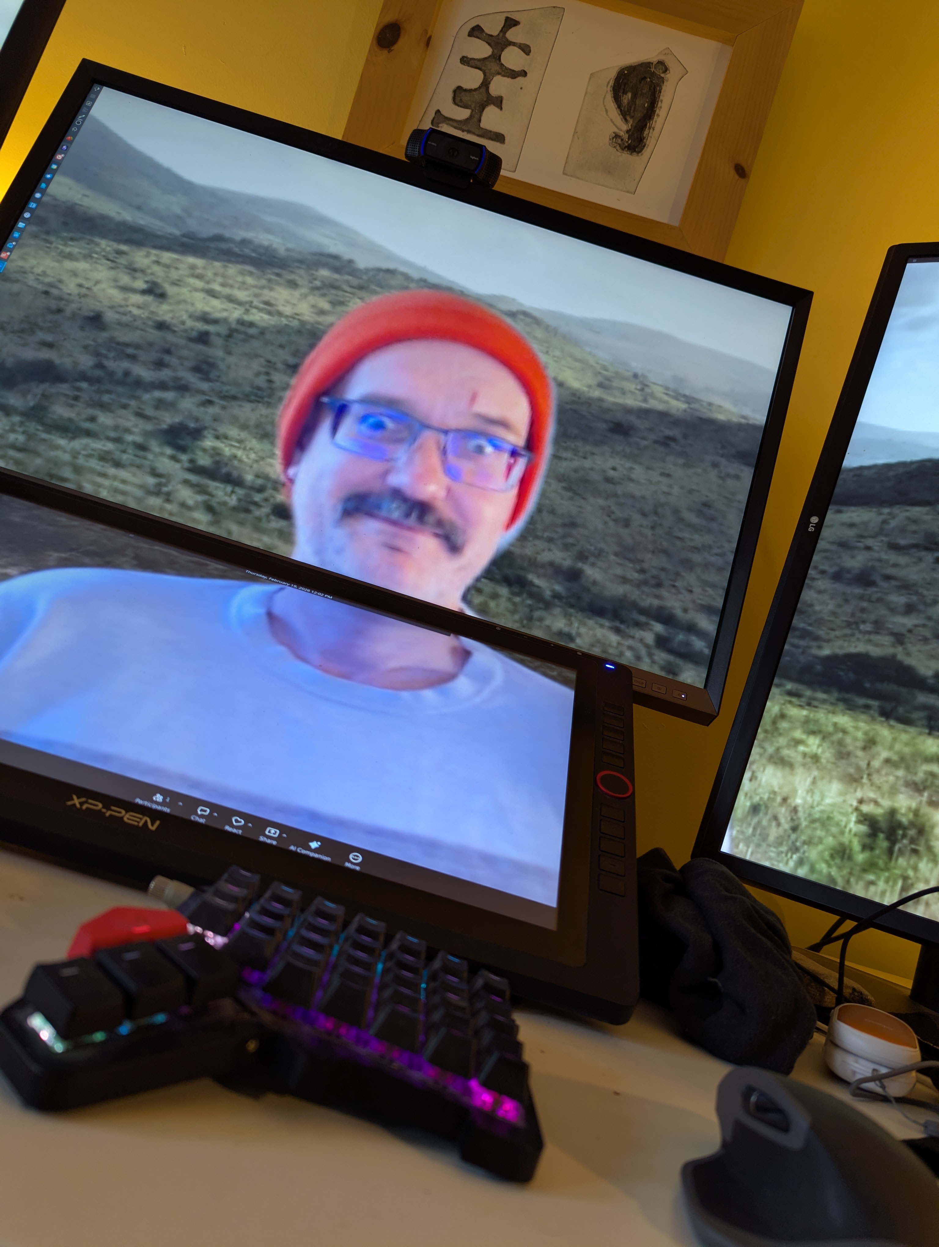 A man in an orange hat on a computer monitor.